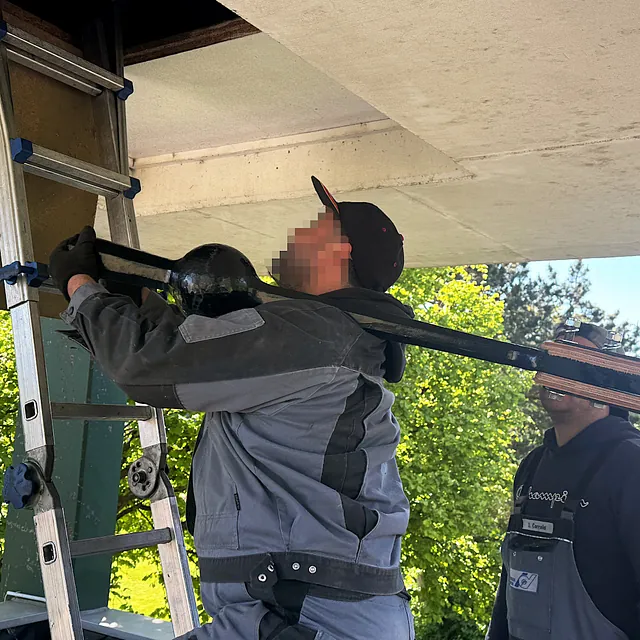 Glockenklöppel wird in den Glockenturm getragen